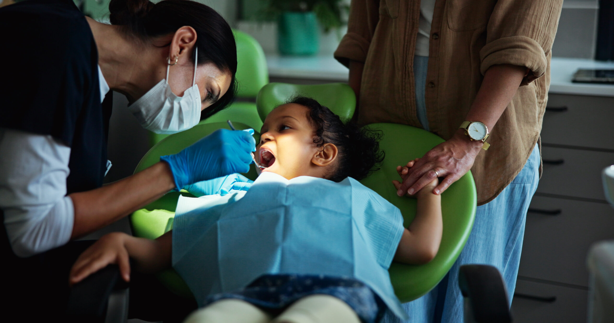 Child at a dental appointment getting an examination.